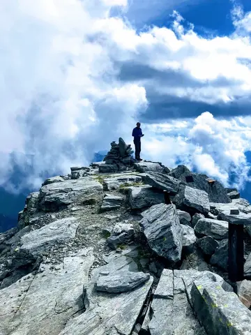 Un escursionista sulla cima rocciosa